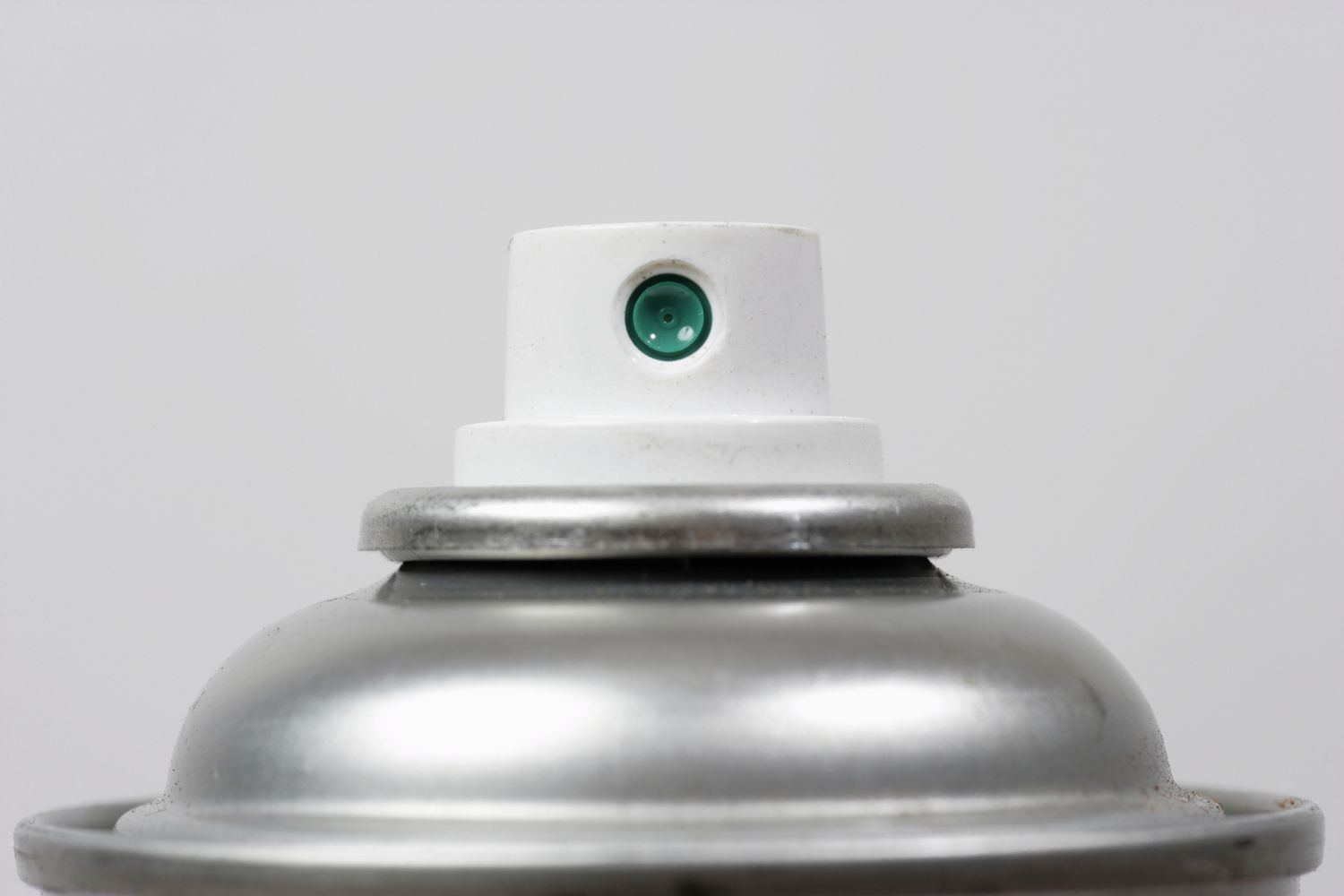 Close up of top of aerosol spray can.